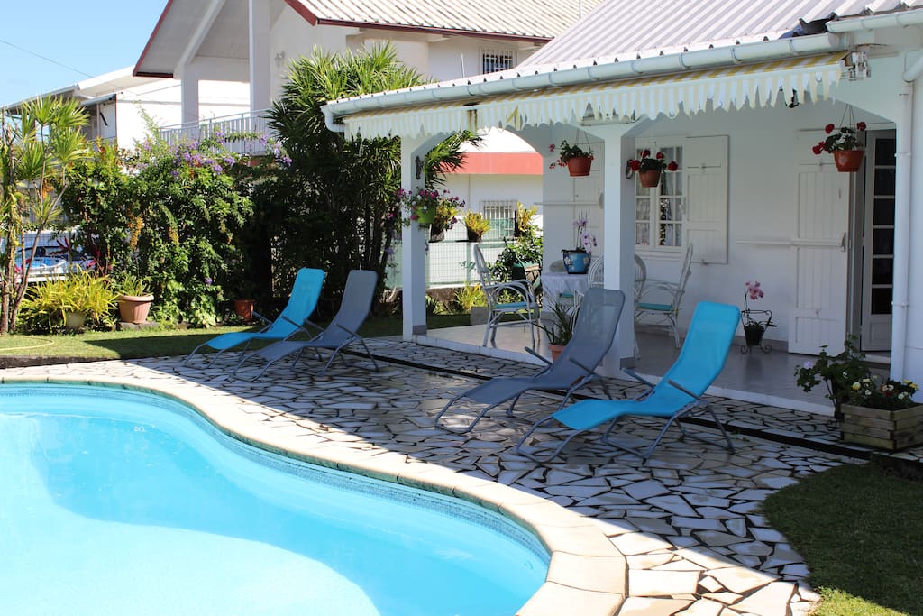 Véranda d'accueil bains de soleil et piscine