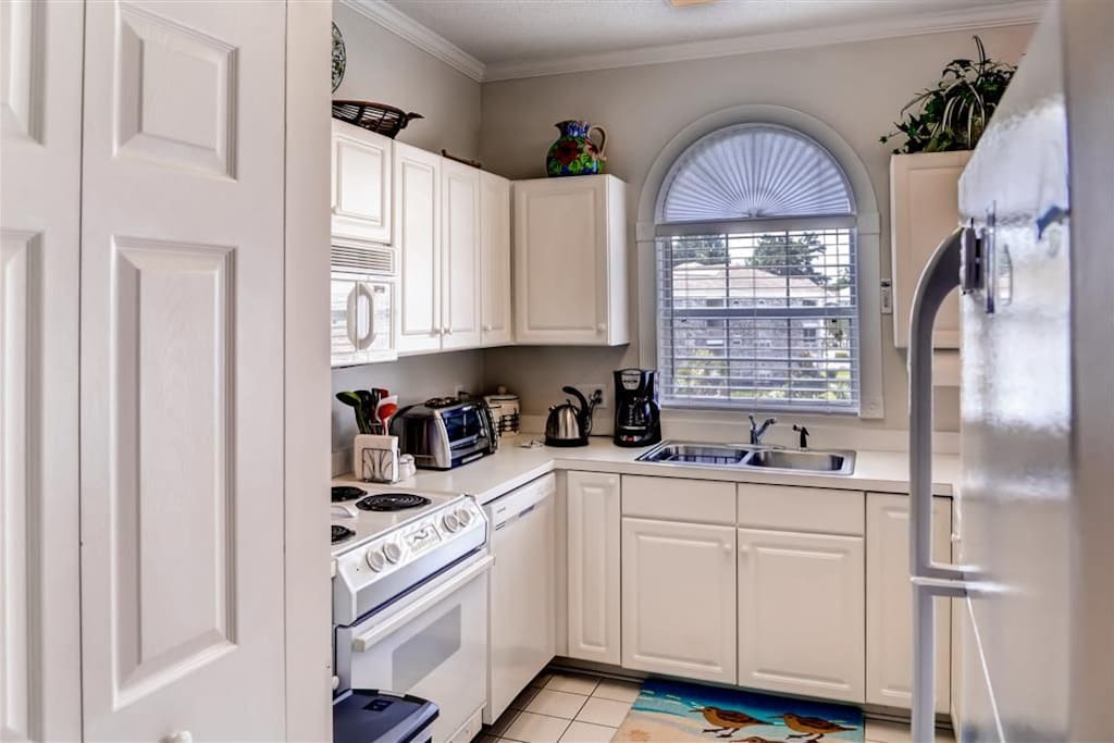 Kitchen is equipped with all necessary appliances.