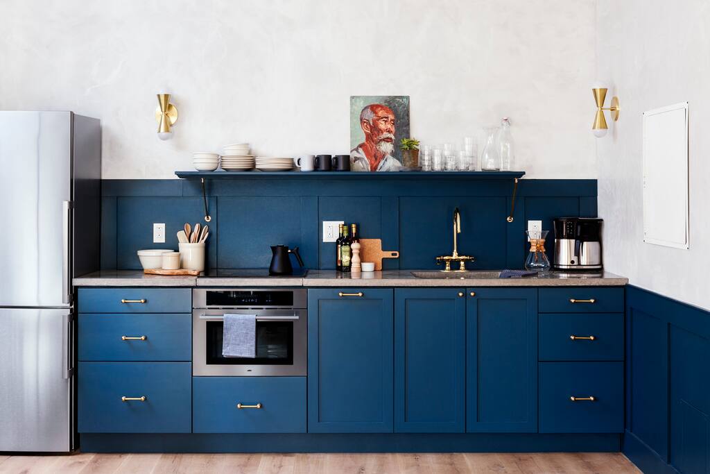 Full kitchen with cooktop, oven and dishwasher.