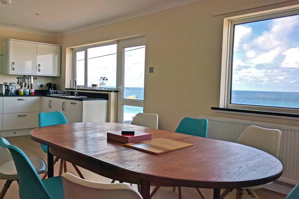 Large kitchen/diner with sea views and access to balcony
