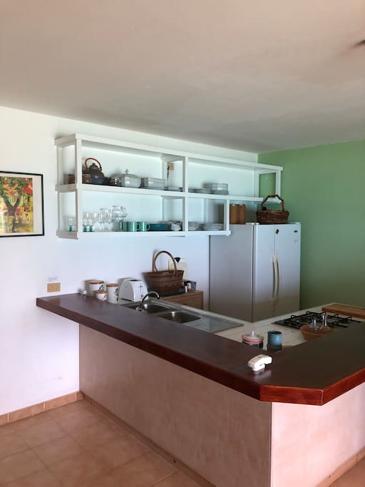 Equipped open kitchen with wrap around breakfast bar.