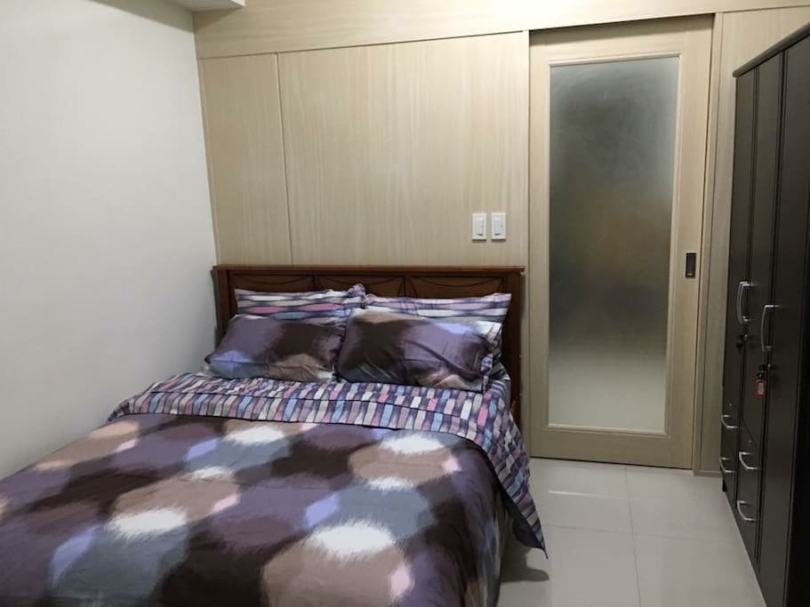 spacious bedroom with a large closet and a very comfortable queen size bed in a fitted sheets, linens and comforters