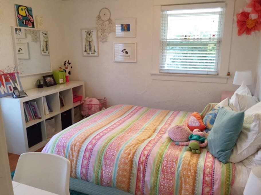 Queen Sized bedroom with closet and a door to the side yard as well.