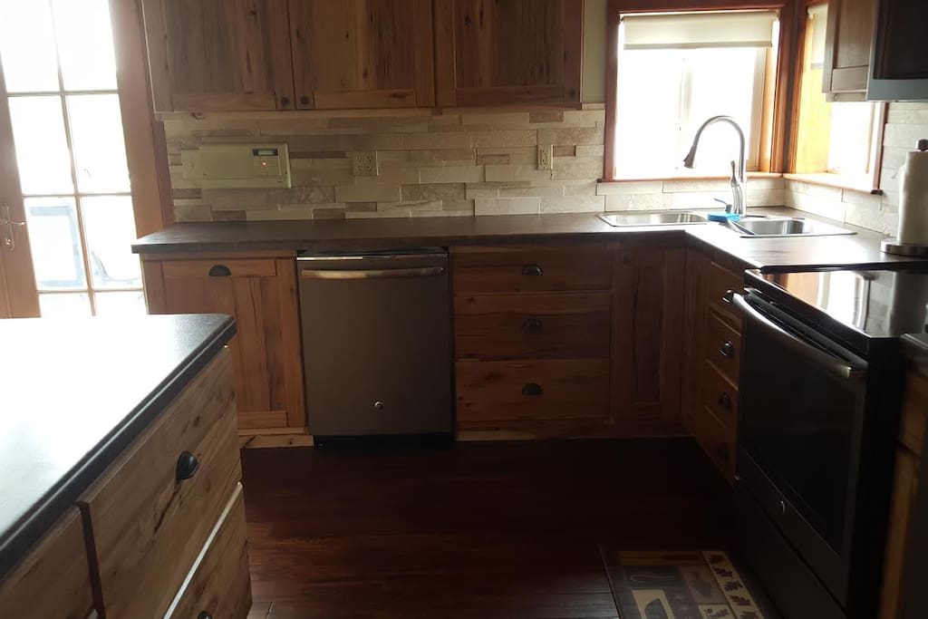 Brand new dishwasher with a beautiful accent of a Travertine back splash.