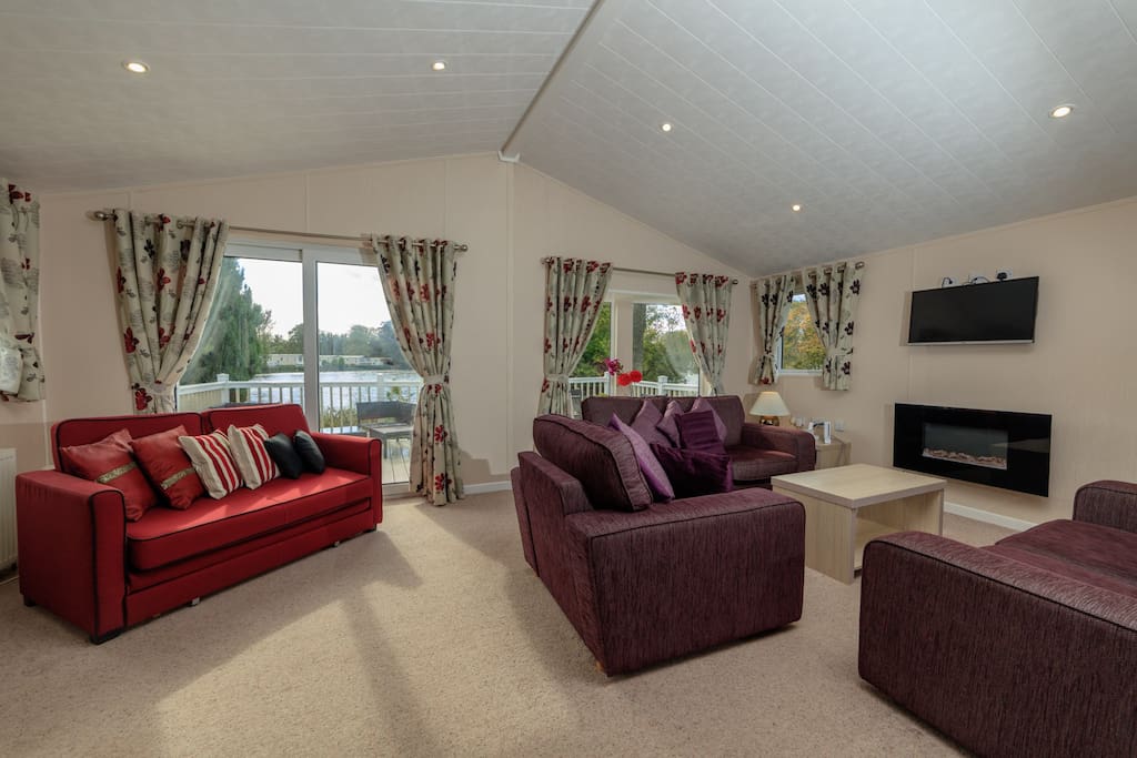 Lounge/living room showing the decking and lake