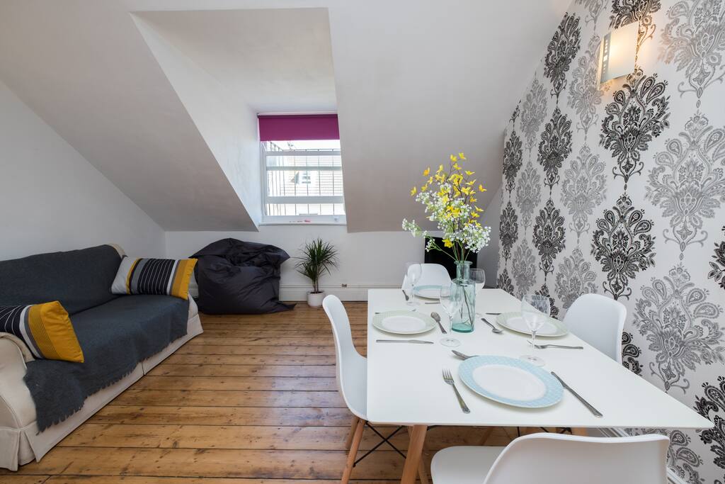 Dining area with cosy sofa and TV