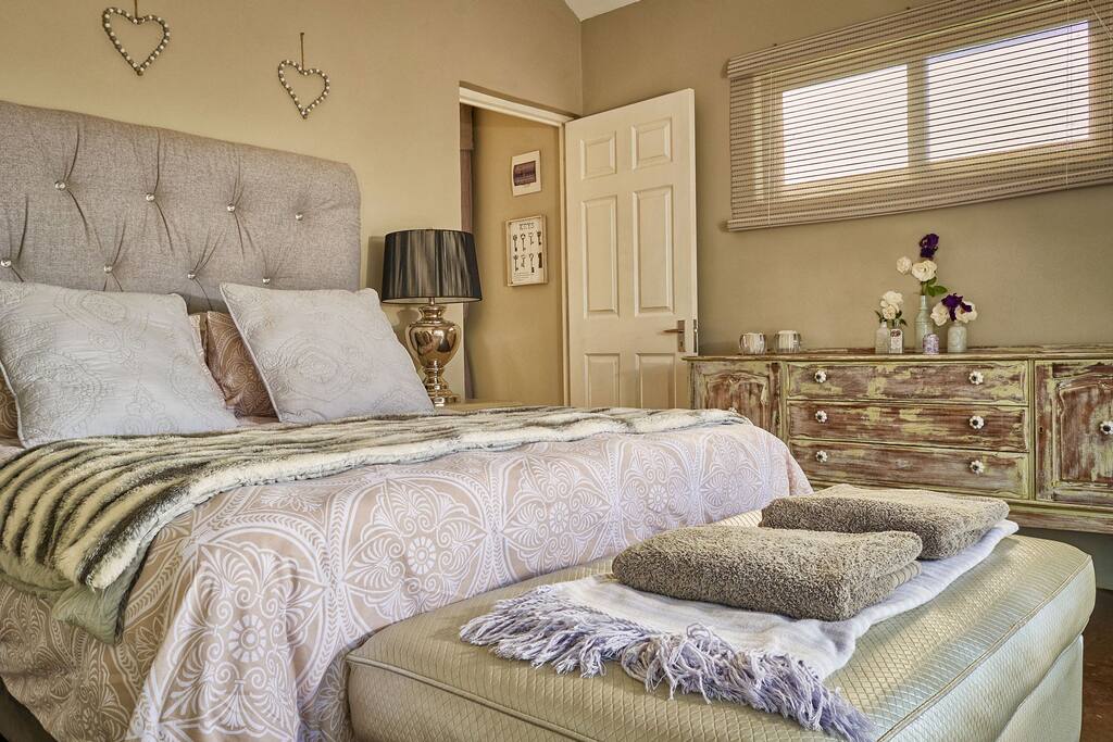 Main bedroom with queen size bed, en-suite bathroom and private patio.