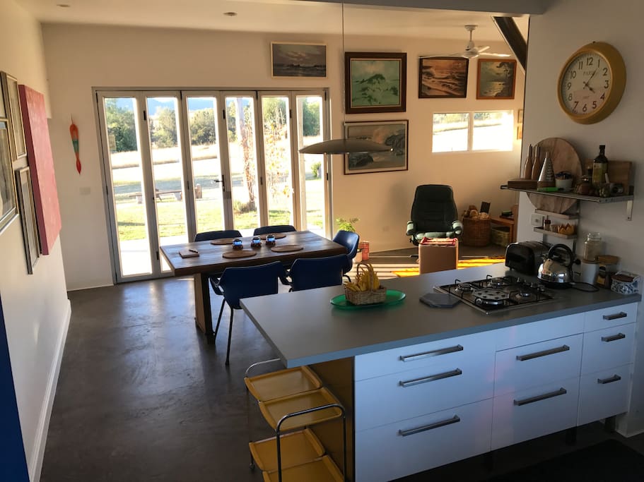 Open plan living, dining and kitchen with high ceilings gives a spacious feel to a small house.