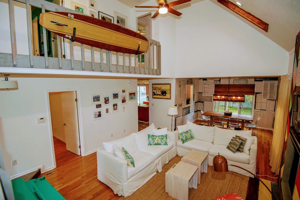 The great room - one of the white couches is a foldout. Downstairs bedroom door is pictured at left with dining room in rear and kitchen in left rear. If you have little ones please note the slats on the upstairs balcony.