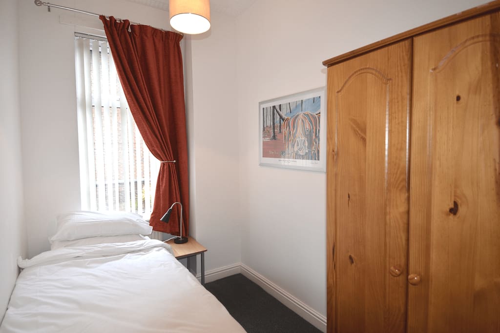 Single bedroom - single bed, wardrobe, bedside table and lamp