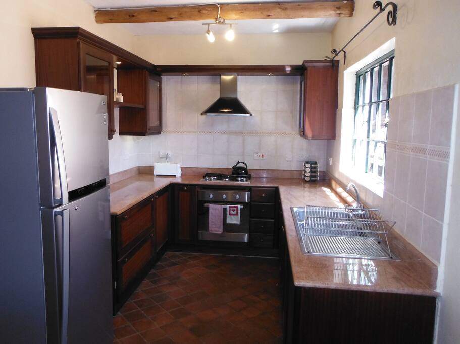Full kitchen with gas stove, large fridge and dishwasher