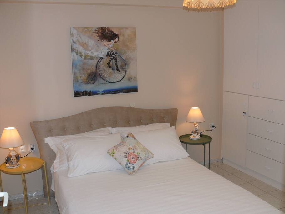 The bedroom has two side tables and a closet. An additional closet is located in the hallway, just outside the bedroom.