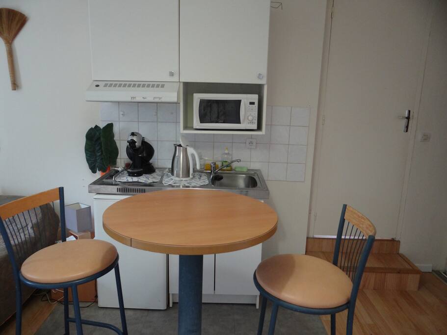 small kitchen with refrigerator, cofee and tea machines