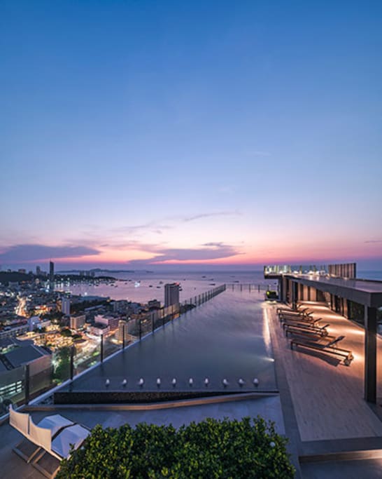 Rooftop swimming pool sunset view