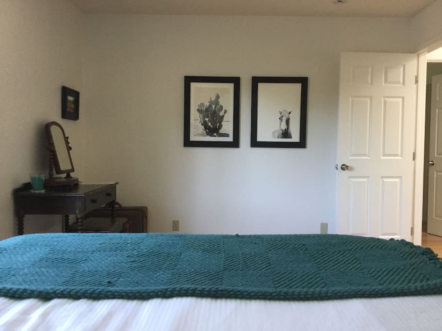 View from your bed including vanity with a mirror - artwork from Minted.
