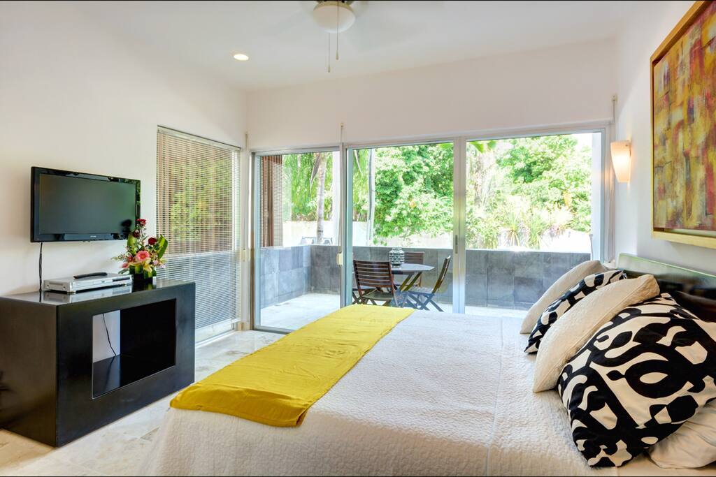 Master bedroom with King size bed, balcony and full bathroom