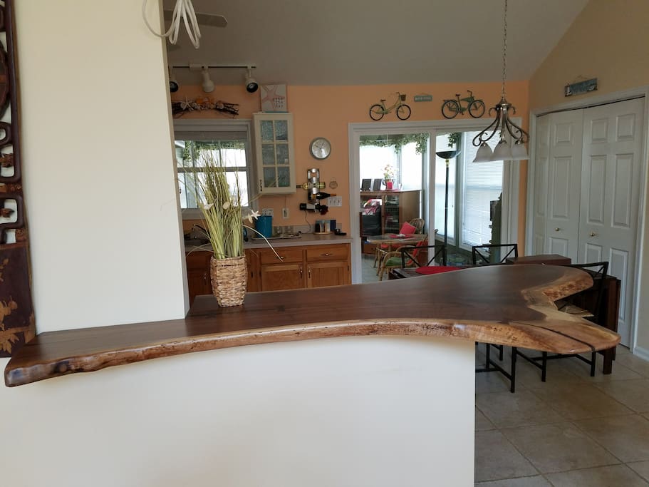 Natural wood bar with 3 stools - great for cocktails or breakfast.