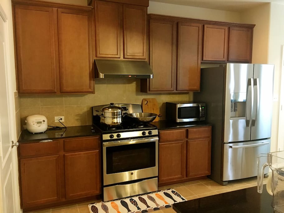 Open and inviting kitchen with all the cooking and dining amenities you desire! Enormous double door stainless steel fridge with ice maker. Fully functional microwave, oven, rice cookers, pots and pans, baking trays, and much more!