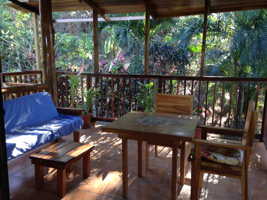 Open area outdoor porch with overhead ceiling fan/light.