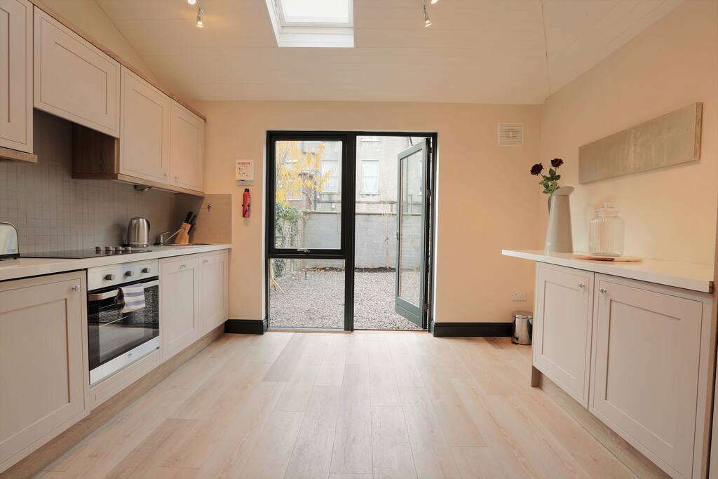 Bright, well appointed kitchen with access to courtyard garden