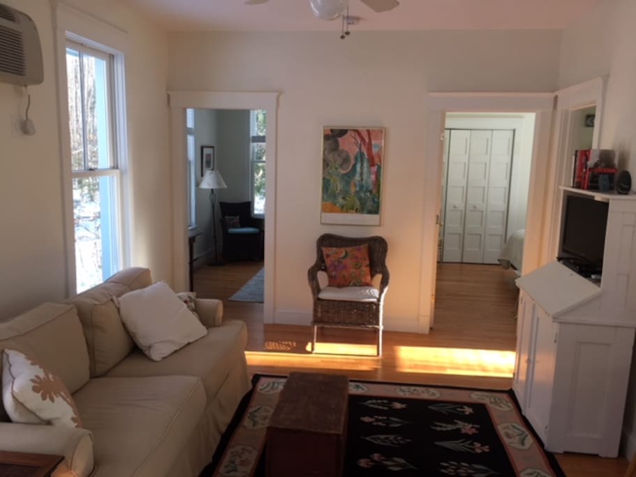 Beautiful and sun-lit living quarters with open concept kitchen and two bedrooms right off of it.