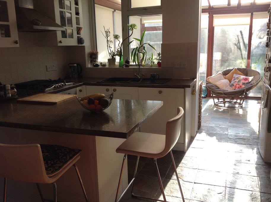 Open plan kitchen dining area overlooking conservatory