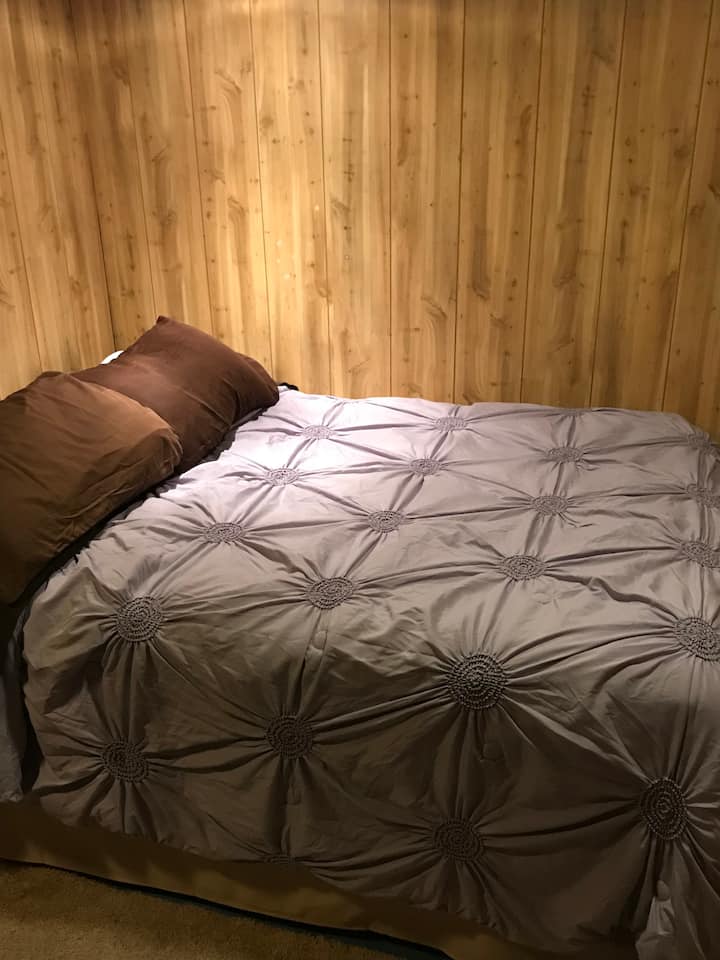 Double bed in bedroom near dining area