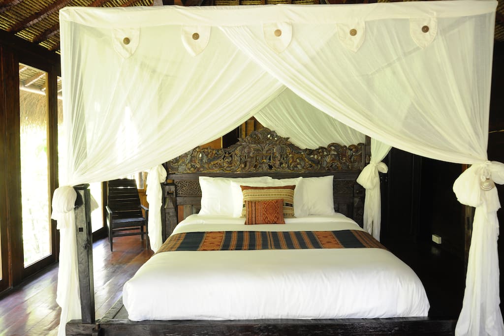 Four poster Antique Balinese wooden bed, with new Italian Queen size mattresses. Adorned in luxurious bed linens + Heirloom-quality textiles from our friends at "Threads of Life Bali".
