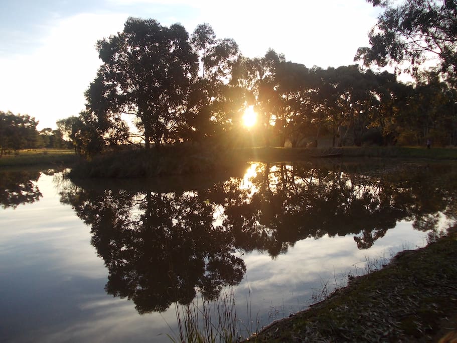 Watch the sun go down over the dam 2 minutes' walk from the verandah