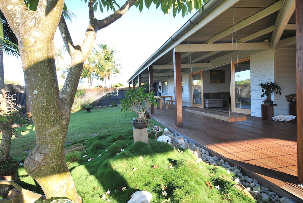 Lush green private garden scattered with bonsai and herbs for the kitchen. Pets are welcome too.