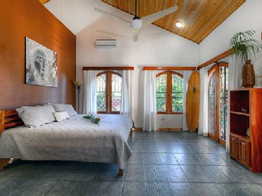 Wind down at night in the master bedroom equipped with a king sized be, AC, and ceiling fan