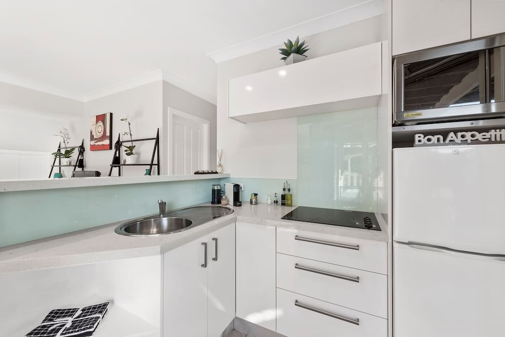 Your Stone bench Kitchenette with full stove top, small Convention Oven / Microwave, Nespresso Coffee machine includes free coffee pods, sugar, milk and milk frother, tea. oil, balsamic vinegar, salt & pepper.