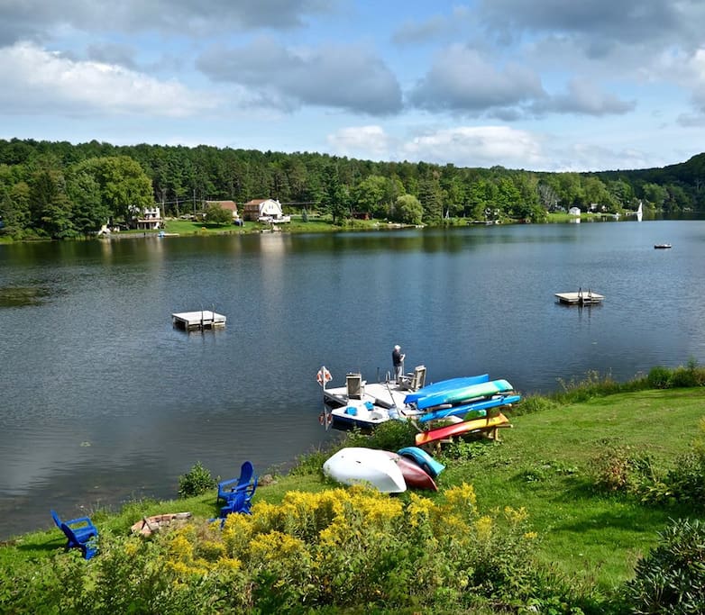 Taken from right next door at your hosts' house, showing our shared waterfront. Your view is very similar from the Helderberg Cottage upper deck. A guest caught some beautiful bass right off of the dock! The boats are available for guests' use.