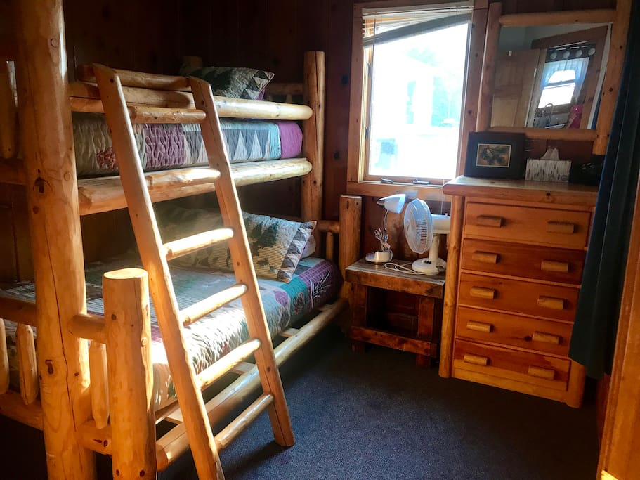 Full/Twin log bunk bedroom with two dressers.
