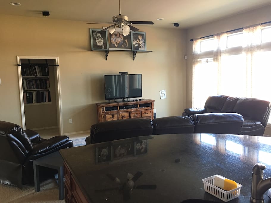 Open concept living area with entrance to Master Bedroom. Couches and recliner all recline.