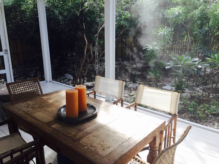 Dining in the breezy screened in porch.