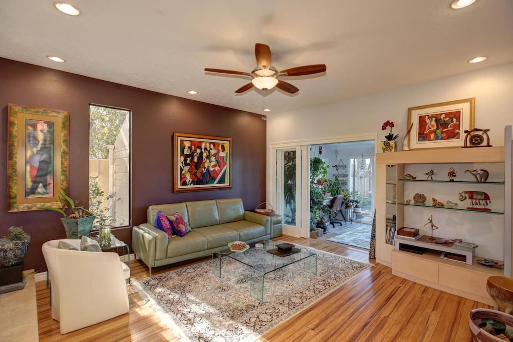 Living room opens to sunroom with futon for sleeping 2 more people