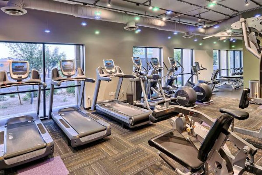 Cardio and weight machines in fitness center.
