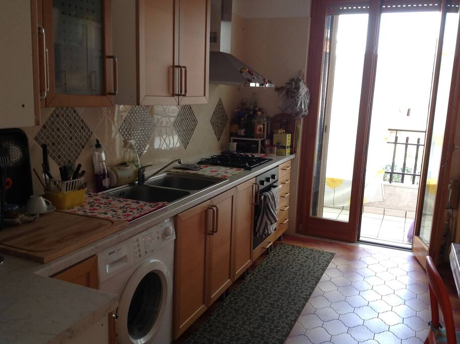Kitchen with waching machine.