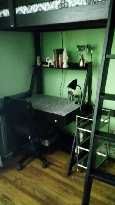 Desk with light, printer, pens and paper available for use.