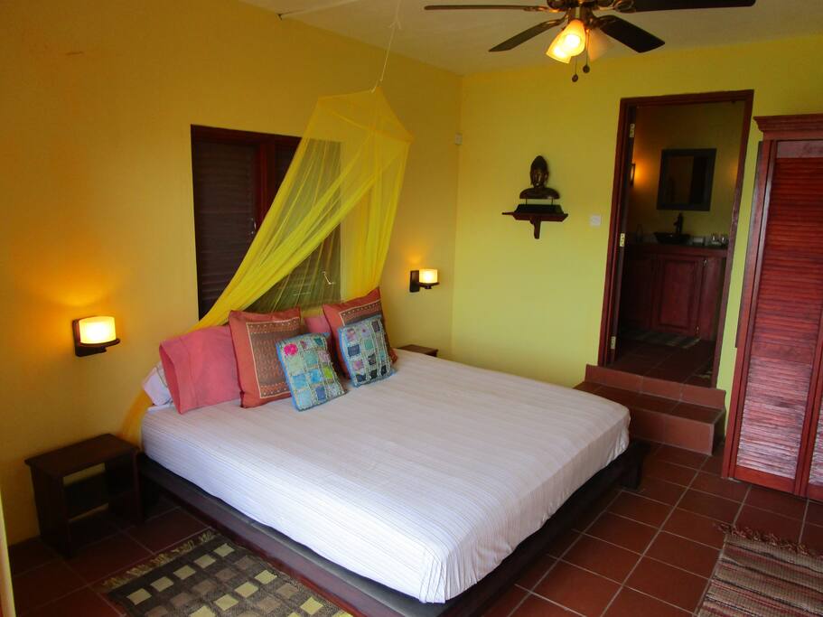 Looking into the room from its balcony with the bathroom door in the background