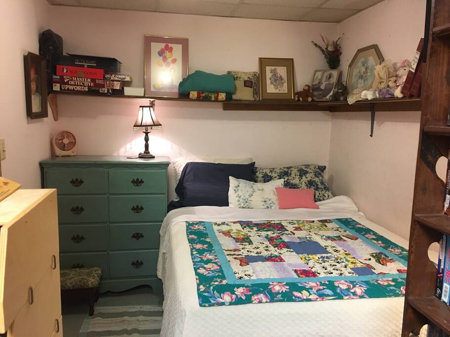 Here is the cozy queen bed. The top 4 drawers of the blue chest are empty if you'd like to unpack your luggage.