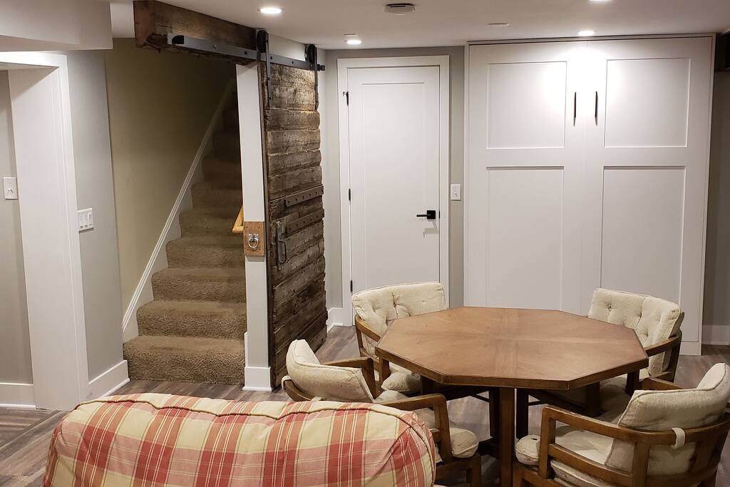 Other half of the studio space. Stairway goes up to the entry way. Tall white doors on the right are the murphy bed (put away). Hallway to the left is to the bathroom.