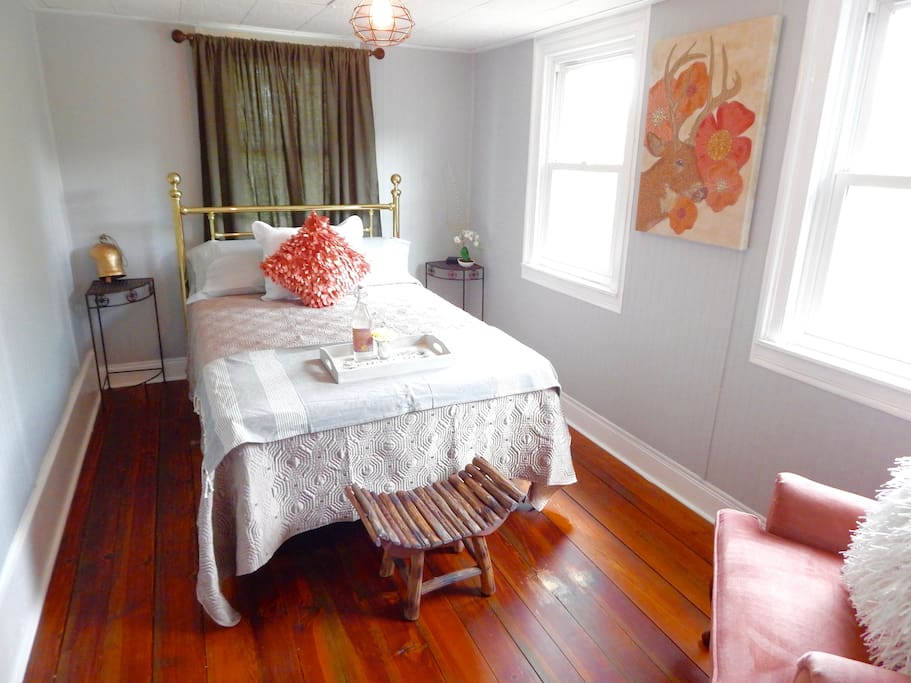 Bedroom two presents a soft feel with a full size brass bed. Luxury bedding