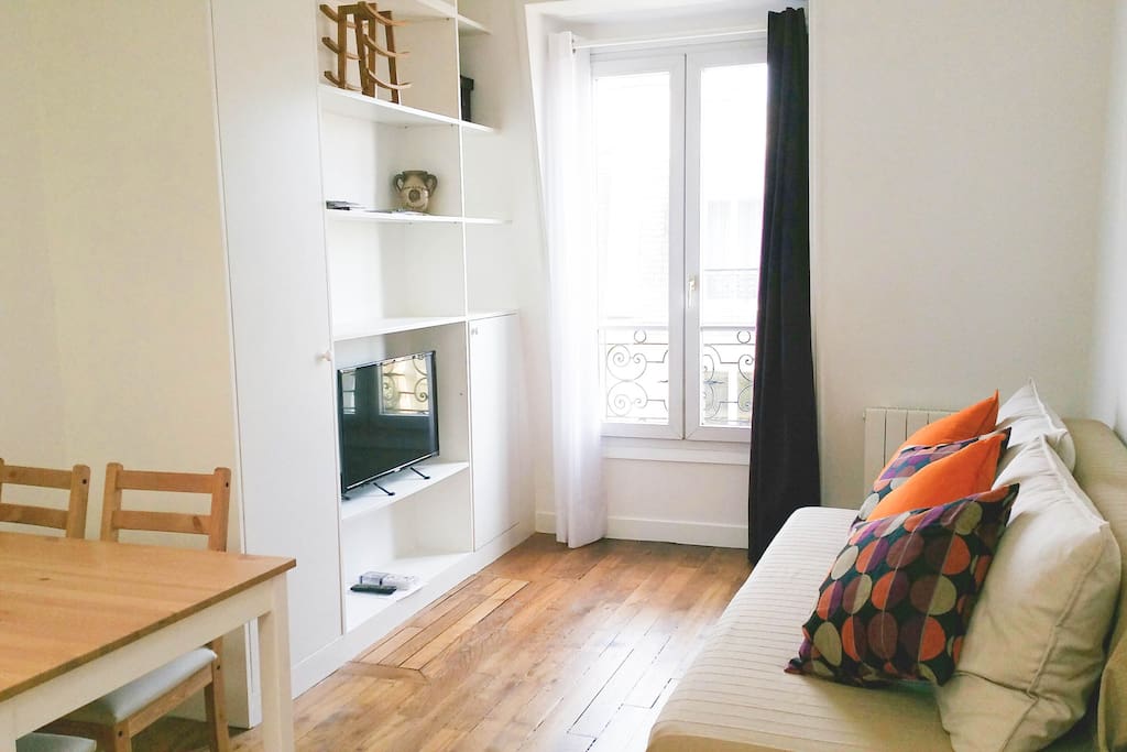 The living room is equipped with a comfy sofa-bed and flat-screen tv.