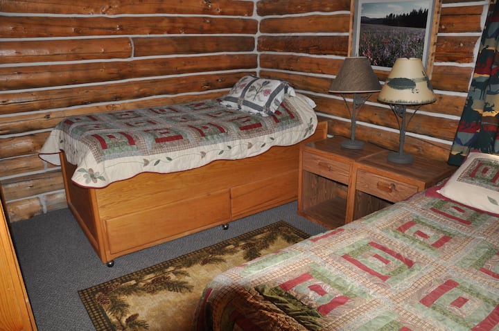 The downstairs bed room has a queen and a single bed with night tables.