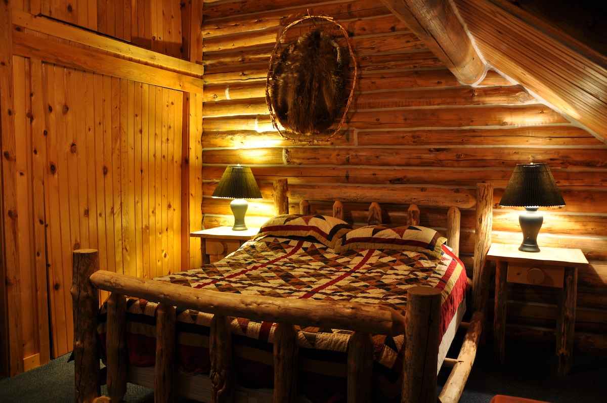 This is the east facing bedroom with a Queen, a Bunk bed, flat couch, and a table by the window.  This is bedroom has the best morning sun with down river view.