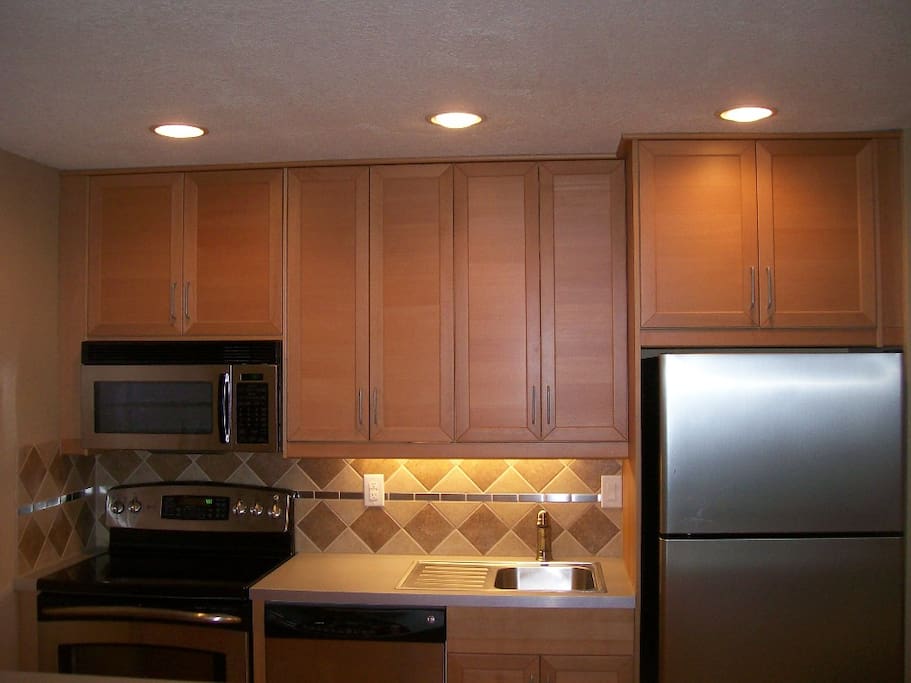 Built in microwave oven and dishwasher. Includes a full complement of kitchenware (4-place setting, utensils, pot, pans, etc.