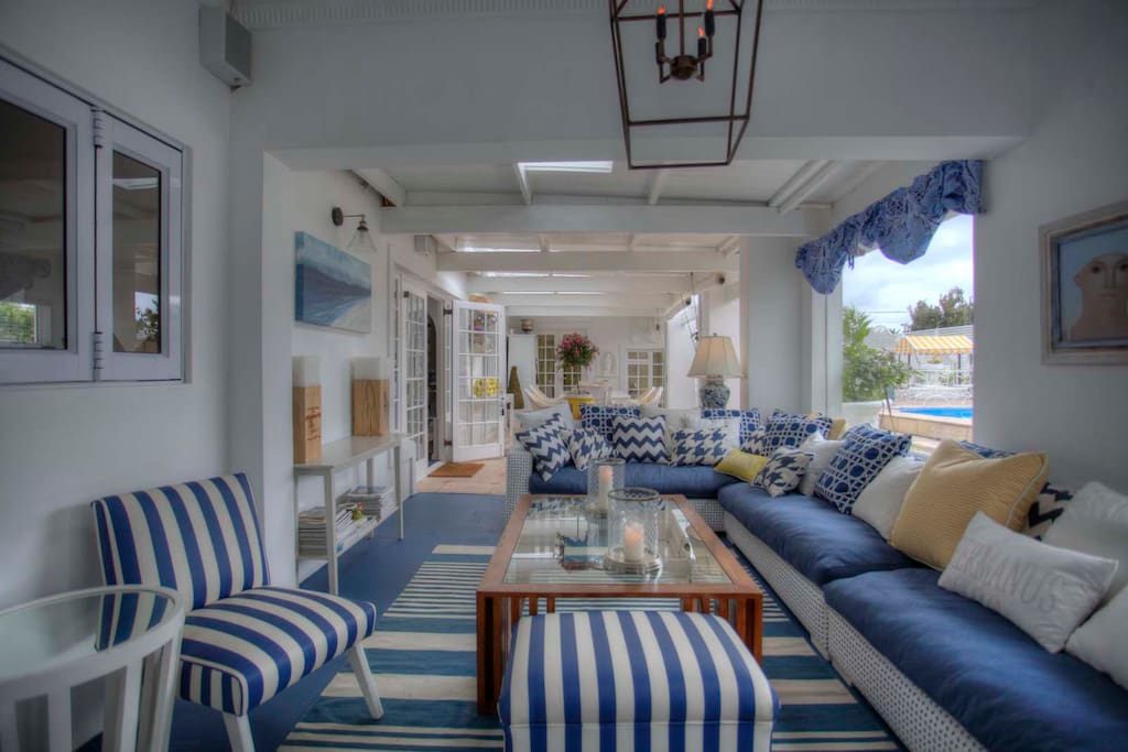 Covered sunny patio with seating area, breakfast dining.