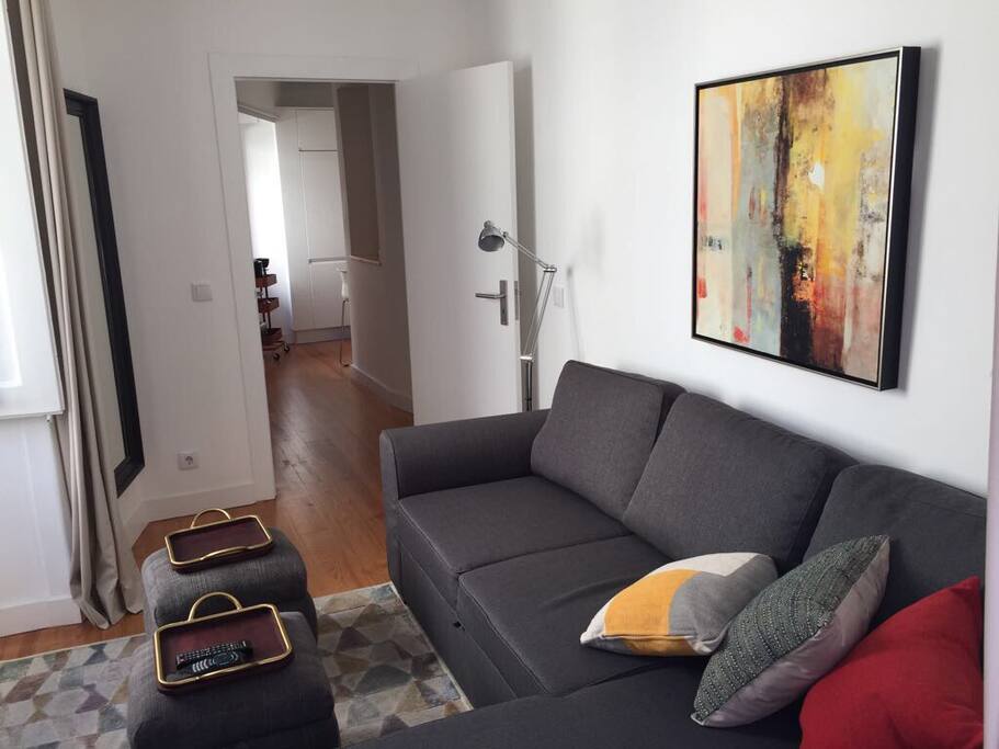 Living room with soft bed and TV
